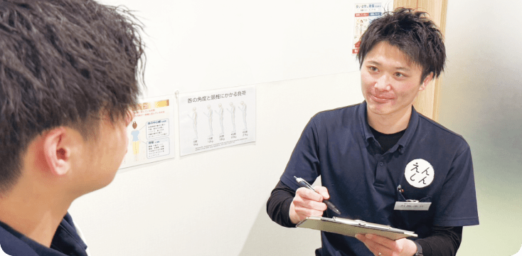 男性整体師が笑顔で問診をしている様子